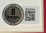 A Beckett Authentication Services sticker with a silver seal, QR code, and number BN38394 is attached to the Shane Wright Signed Framed 8x10 Seattle Kraken Photo by Sports Integrity.