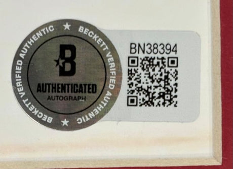 A Beckett Authentication Services sticker with a silver seal, QR code, and number BN38394 is attached to the Shane Wright Signed Framed 8x10 Seattle Kraken Photo by Sports Integrity.