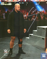 Solo Sikoa, in black gear with a knee brace, stands by metal steps in the WWE arena in this autographed 8x10 debut photo from Sports Integrity. Features WWE logos and certified authentic by Fanatics.