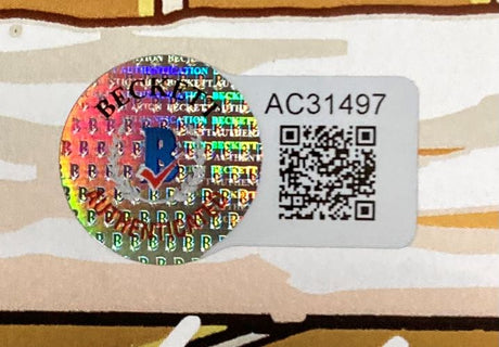 The Stan Lee Signed Framed 13x19 JJ Kirby Photo by Sports Integrity features a holographic Beckett authentication sticker with QR code and serial number AC31497 on a light brown and beige printed background.