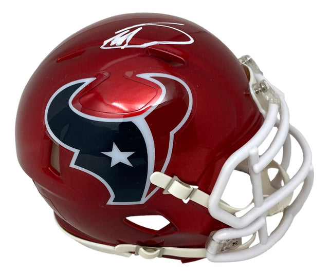 A Stefon Diggs signed Houston Texans Flash Mini Speed Helmet by Sports Integrity, featuring the team logo, a white facemask, and his autograph on top.
