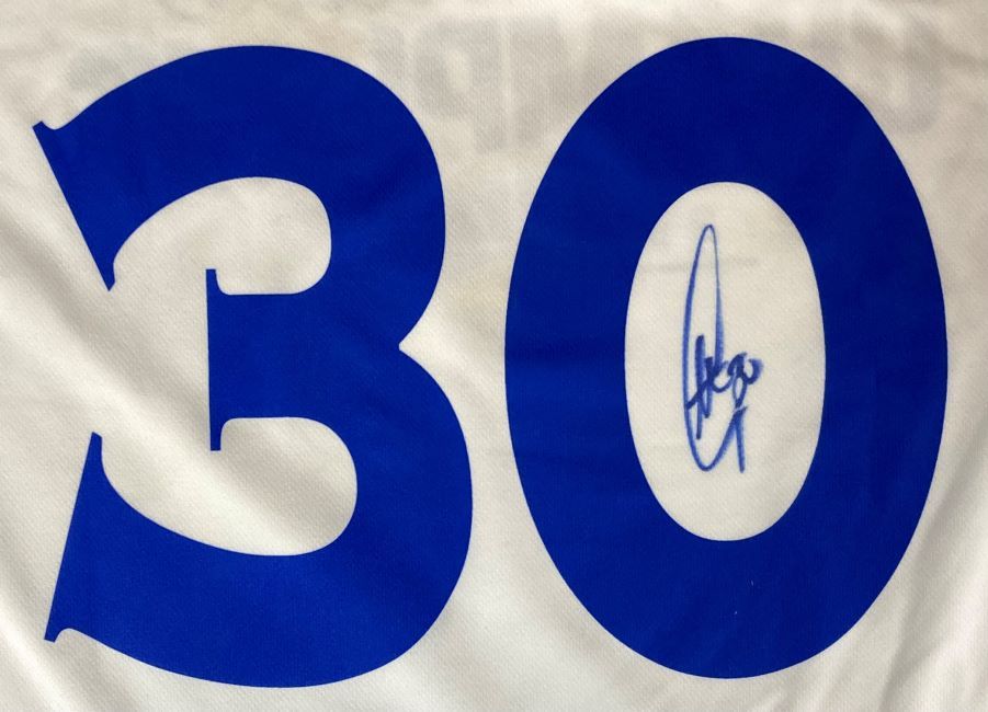The Stephen Curry Signed Warriors Adidas Basketball Jersey 2017 Champions by Sports Integrity features white fabric with a large blue number 30, and Curry’s signature inside the zero.