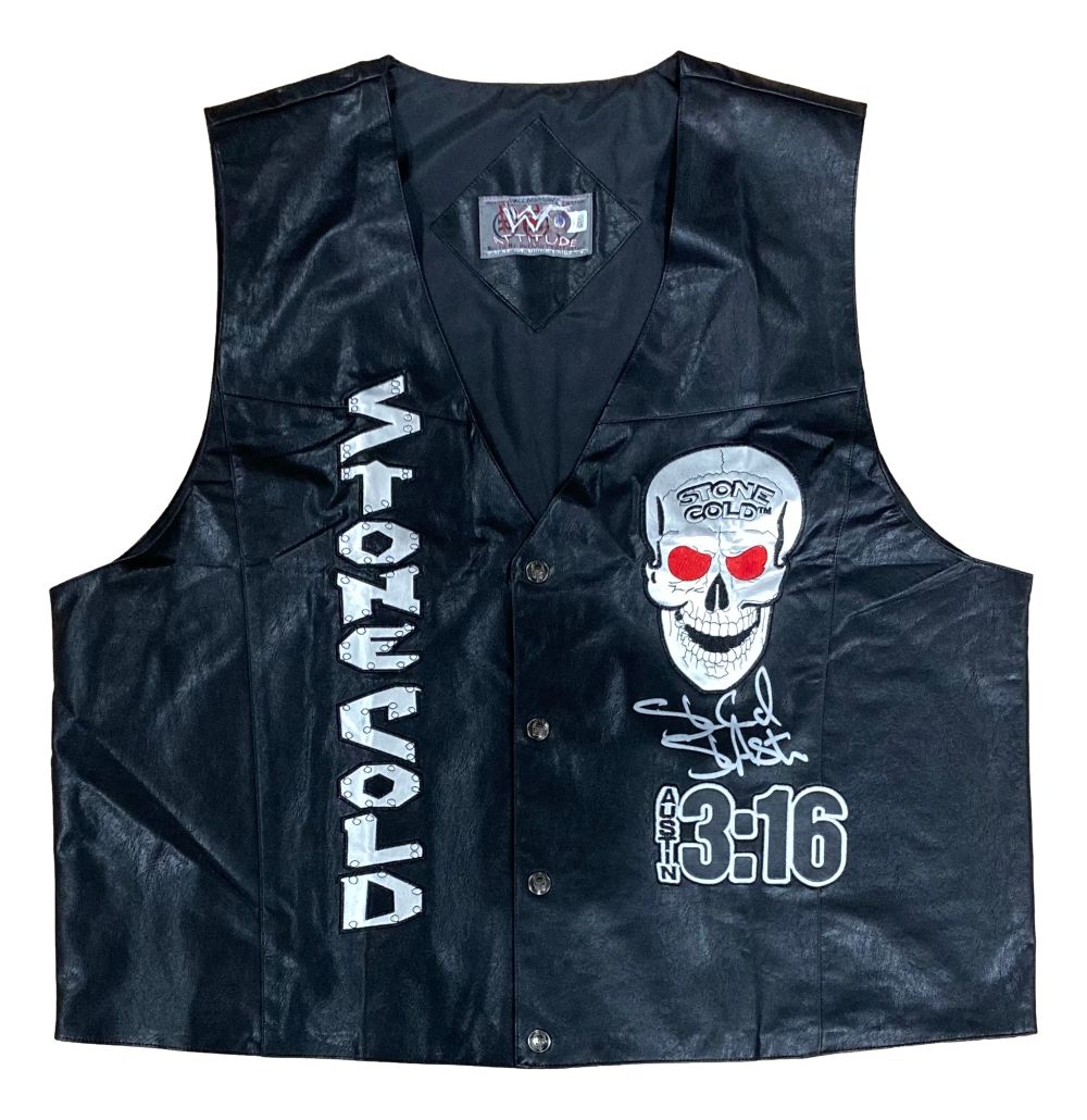 The Sports Integrity Stone Cold Steve Austin Signed Autographed WWE Skull Vest BAS is a black leather vest featuring bold "STONE COLD" text, a skull graphic with red eyes, "AUSTIN 3:16," and an authentic signature.