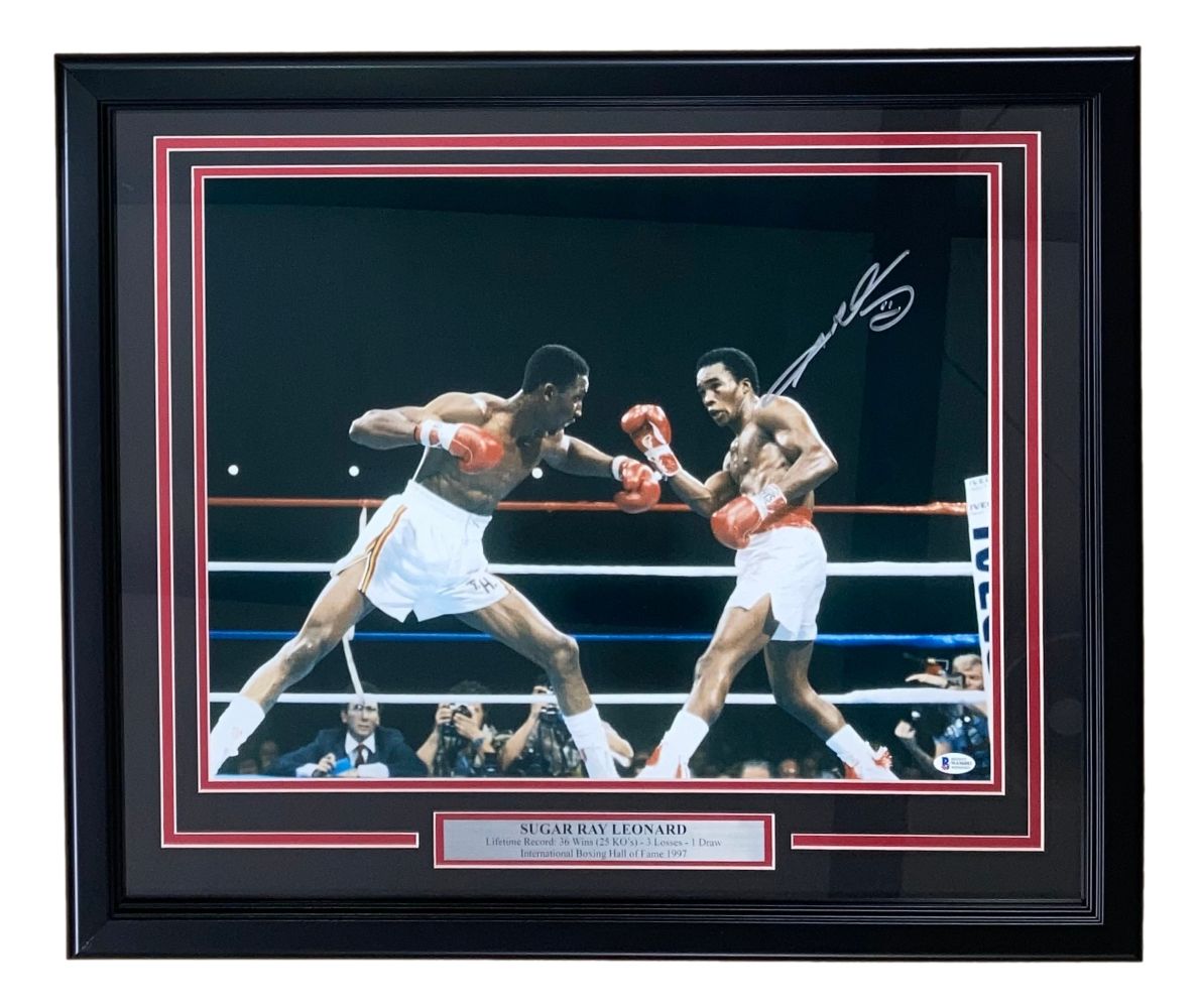 Sports Integrity Sugar Ray Leonard Signed Framed 16x20 Boxing Swing Photo BAS ITP features an autographed action shot of Leonard in the ring, with a metal plaque displaying his name.
