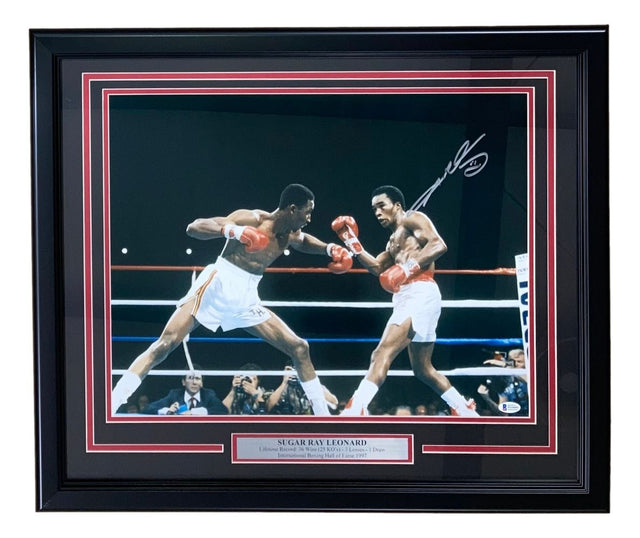 Sports Integrity Sugar Ray Leonard Signed Framed 16x20 Boxing Swing Photo BAS ITP features an autographed action shot of Leonard in the ring, with a metal plaque displaying his name.