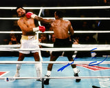 The Sports Integrity Sugar Ray Leonard Signed 8x10 Boxing Punch Horizontal Photo shows Leonard, in white trunks, being punched by an opponent in black trunks in the ring, with a large blue autograph and spectators in the background.