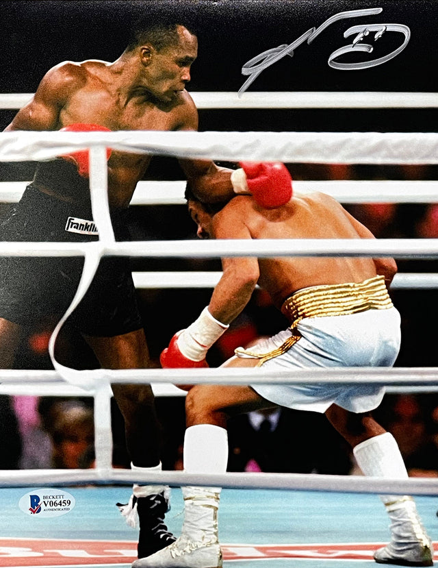 The Sports Integrity Sugar Ray Leonard Signed 8x10 Boxing Duck Photo BAS shows two male boxers in the ring, with one throwing a punch as his opponent ducks. A signature appears at the top of the image.
