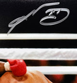 A close-up of the Sports Integrity Sugar Ray Leonard Signed 8x10 Boxing Duck Photo BAS, featuring a red glove and silver autograph above white boxing ropes on a dark background.