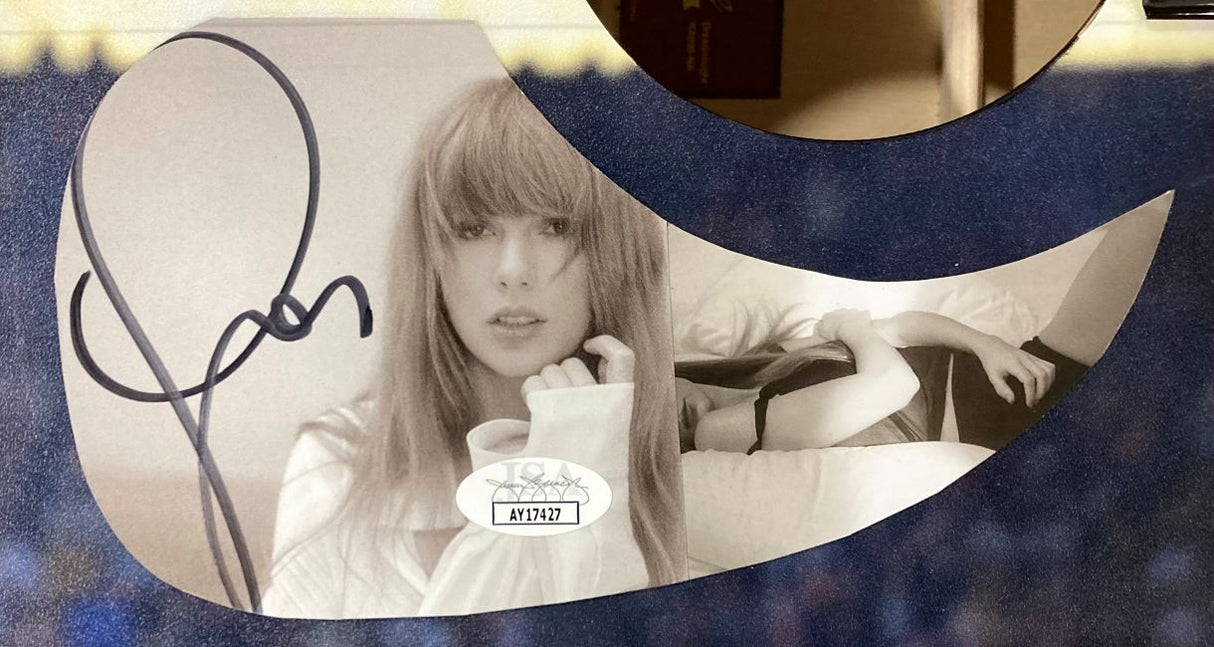A Taylor Swift Signed 41" Red Jacket Graphic Acoustic Guitar by Sports Integrity features her autograph and a JSA authenticity sticker.