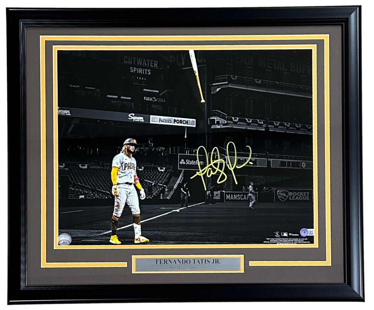 Sports Integrity Fernando Tatis Jr Signed Framed 16x20 San Diego Padres Spotlight Photo features the player in color with a gold signature and nameplate, set against a black and white background. BAS authenticated.