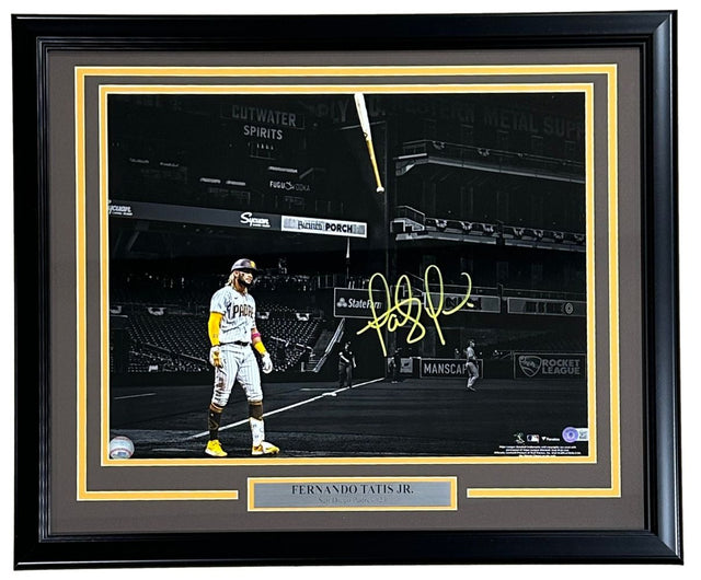 Sports Integrity Fernando Tatis Jr Signed Framed 16x20 San Diego Padres Spotlight Photo features the player in color with a gold signature and nameplate, set against a black and white background. BAS authenticated.
