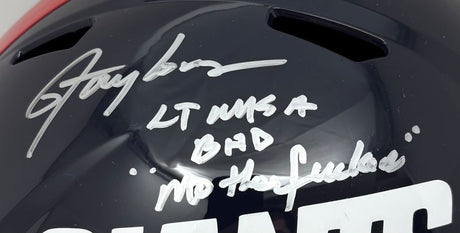A close-up of the Sports Integrity Lawrence Taylor Signed New York Giants FS T/B Speed Replica Helmet BAD MF BAS, autographed in silver with “LT NYG #56 BHD No has beens.”.