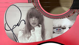This Taylor Swift Signed 38" Tortured Poets Department Pink Acoustic Guitar from Sports Integrity features her black signature, a black-and-white photo of Taylor with long hair and bangs, and PSA authentication sticker AO63035.