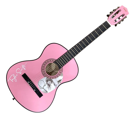 The Taylor Swift Signed 38" Tortured Poets Department Pink Acoustic Guitar by Sports Integrity features a pink finish, her signature on the body, and a black-and-white photo of Taylor Swift near the sound hole.