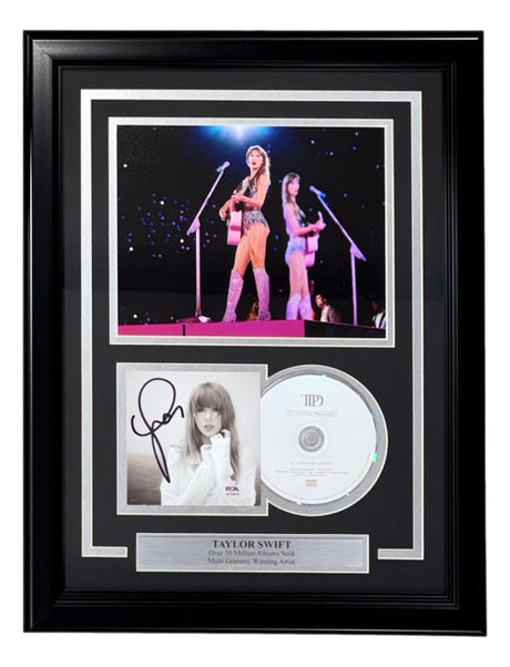 Sports Integrity’s Taylor Swift Signed Framed Insert features an 8x10 concert photo with a pink guitar, a signed portrait authenticated by PSA/DNA, a CD, and a nameplate highlighting her Grammy wins.