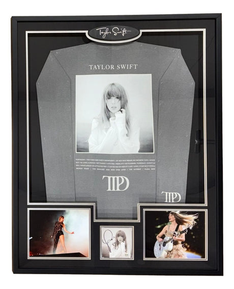 The Sports Integrity Taylor Swift Framed Swift Tortured Poets Department Shirt includes a PSA/DNA signed insert and is beautifully displayed with themed decorative elements.