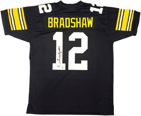The Terry Bradshaw Pittsburgh Signed Black Football Jersey by Sports Integrity features yellow sleeve stripes, "BRADSHAW" in yellow above a large white autographed #12. BAS authenticated.