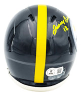 The Sports Integrity Terry Bradshaw Signed In Yellow Pittsburgh Steelers Mini Speed Helmet BAS features a yellow autograph with #12, the team logo, a yellow central stripe, and authentication stickers near the base.