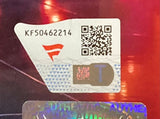 A close-up of a sticker on The Miz Signed Framed 8x10 WWE Photo Fanatics by Sports Integrity, showing code KF50462214, a QR code, red logo, blue T, and security patterns on a shiny background.