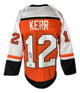 The Sports Integrity Tim Kerr Philadelphia Signed Orange Hockey Jersey features Kerr’s name, #12 on back and sleeves, and an autograph on the number.