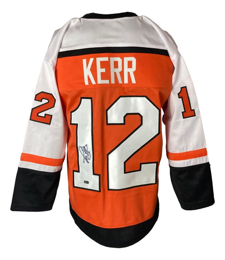 The Sports Integrity Tim Kerr Philadelphia Signed Orange Hockey Jersey features Kerr’s name, #12 on back and sleeves, and an autograph on the number.