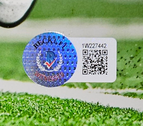A Tommy Devito Signed 8x10 New York Giants Photo by Sports Integrity, featuring BAS ITP authentication sticker 1W227442, is shown on a grassy surface.