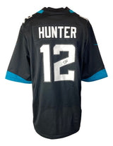 The Sports Integrity Travis Hunter Signed Jacksonville Jaguars Black Nike Game Replica Jersey features HUNTER and number 12 in white with teal accents.