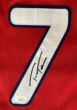 The Sports Integrity Trea Turner Philadelphia Signed Red Baseball Jersey features a large white number 7 with a dark blue outline, Trea Turner’s autograph in black, and a JSA authentication sticker at the bottom left.
