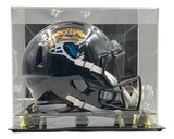 The Trevor Lawrence Signed Jaguars Full Size Replica Speed Helmet by Sports Integrity is showcased inside a clear acrylic display case with gold accents.