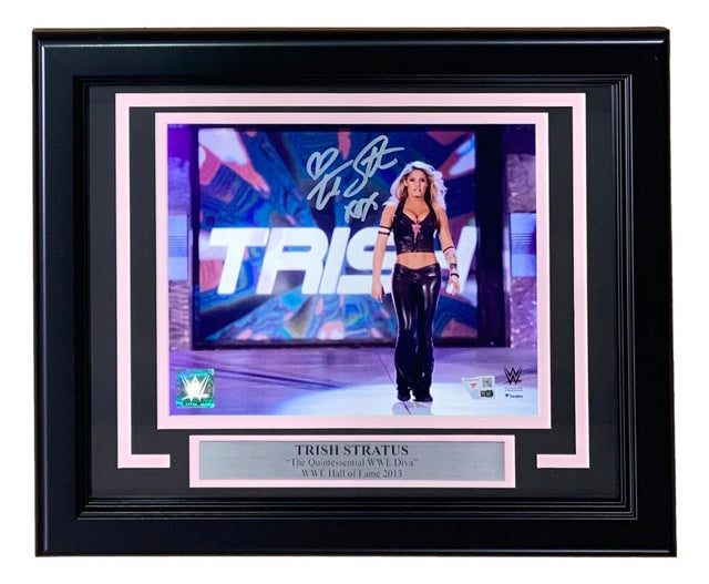 The Sports Integrity Trish Stratus Signed Framed 8x10 WWE Entrance Photo by Fanatics features her autograph and a plaque reading: TRISH STRATUS The Quintessential WWE Diva WWE Hall of Fame 2013.