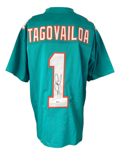The Sports Integrity Tua Tagovailoa Miami Signed Teal Football Jersey (BAS) features Tagovailoa’s name, number 1, and a visible autograph on the back.