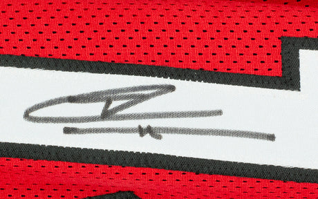 A close-up of the Tyler Herro Miami Signed Red Basketball Jersey by Sports Integrity, showing a bold black autograph on the white section with black trim; a JSA-authenticated collectible for fans.