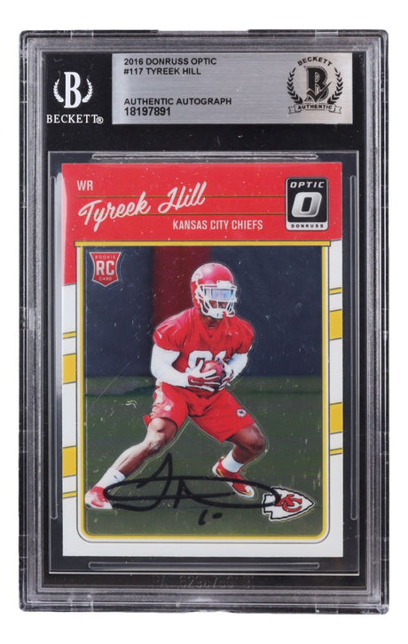 The Sports Integrity Tyreek Hill Signed 2016 Donruss Optic #117 Kansas City Chiefs Rookie Card BAS features his autograph and shows him in a red Chiefs uniform holding a football, encased for protection.