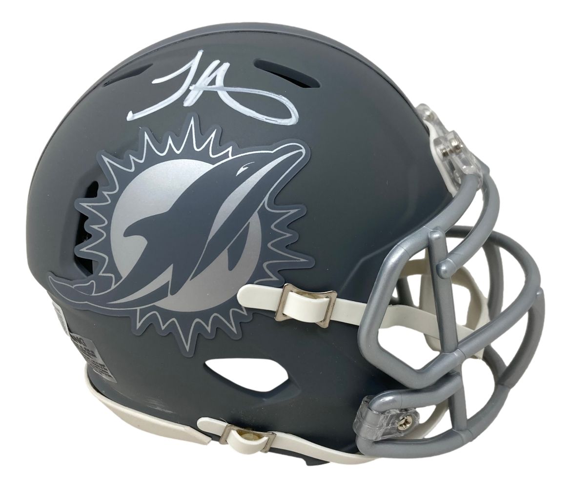 The Tyreek Hill Signed Miami Dolphins Slate Mini Speed Helmet by Sports Integrity features a slate design with the team logo, silver facemask, and Tyreek Hill's white autograph on top.