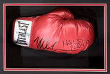 A Mike Tyson and Evander Holyfield signed red Everlast right-hand boxing glove is showcased in a black and red frame by Sports Integrity. The autographs and "HELØ PL 4:13" inscription are visible on the glove's surface.