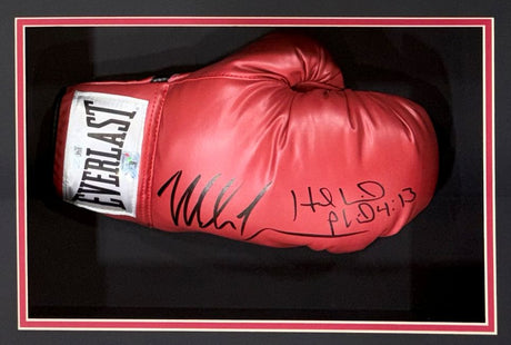 A Mike Tyson and Evander Holyfield signed red Everlast right-hand boxing glove is showcased in a black and red frame by Sports Integrity. The autographs and "HELØ PL 4:13" inscription are visible on the glove's surface.