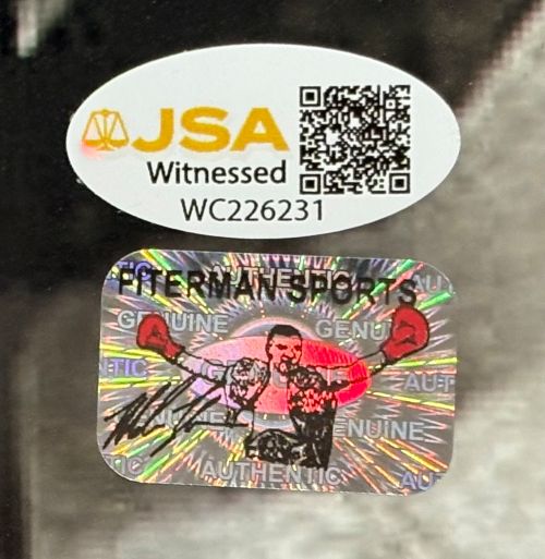 Sports Integrity Mike Tyson Signed Framed 16x20 Spotlight Boxing Photo with a JSA QR hologram above a Hitman Sports holographic sticker showing a boxer with red gloves and Mike Tyson’s black signature.