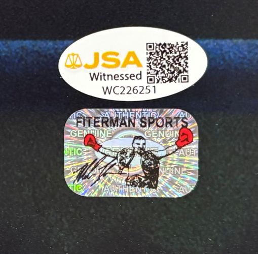 A JSA Witnessed authentication sticker with QR code and serial number WC226251 is above a Sports Integrity holographic sticker on a Mike Tyson Signed To Left 16x20 Boxing Stare Photo.