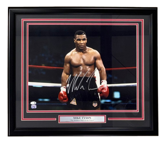 This Sports Integrity framed 16x20 photo features Mike Tyson shirtless in the ring with red gloves, hand-signed and authenticated by a JSA QR hologram. Plaque reads: Mike Tyson "The Baddest Man on the Planet.