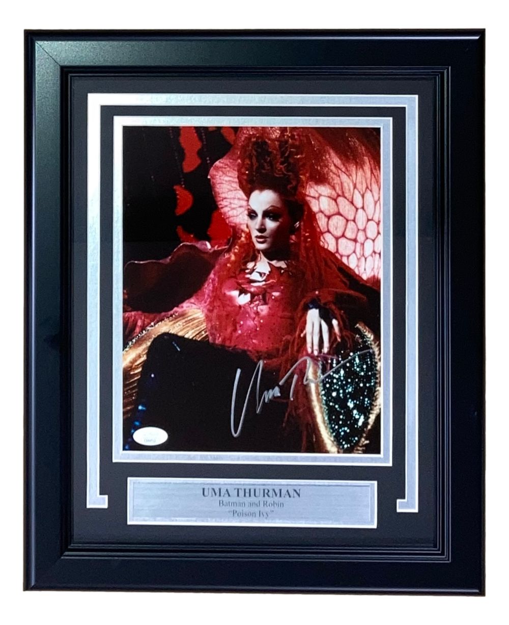 The Sports Integrity Uma Thurman Signed Framed 8x10 Batman & Robin Poison Ivy Photo features her autograph and a metal nameplate, capturing her vibrant red costume from the film. Authenticated by JSA.