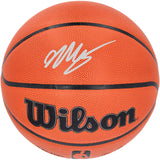 A Victor Wembanyama Spurs Signed Authentic NBA Wilson I/O Basketball by Sports Integrity features a white autograph on the upper part, with classic black lines and textured orange surface.