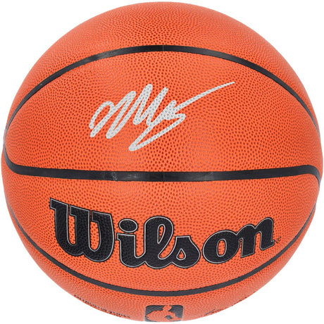 A Victor Wembanyama Spurs Signed Authentic NBA Wilson I/O Basketball by Sports Integrity features a white autograph on the upper part, with classic black lines and textured orange surface.