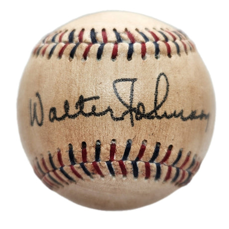 A close-up of the Sports Integrity Walter Johnson Senators Replica Baseball, showcasing red and blue stitching and a circa 1930s facsimile autograph.