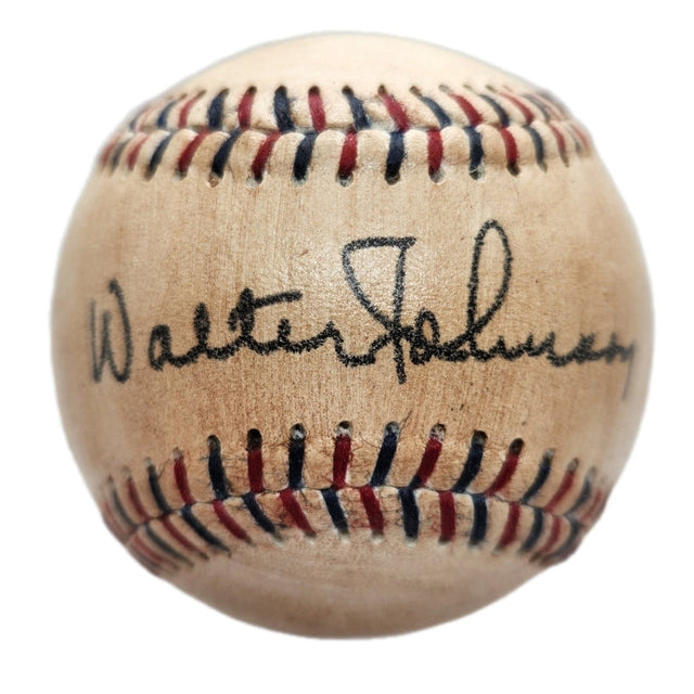 A close-up of the Sports Integrity Walter Johnson Senators Replica Baseball, showcasing red and blue stitching and a circa 1930s facsimile autograph.