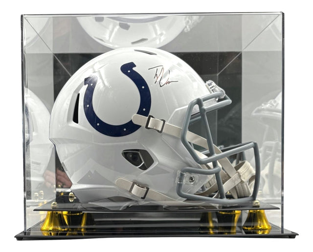 The Sports Integrity Tyler Warren Signed Indianapolis Colts FS Speed Replica Helmet, featuring a blue horseshoe logo, is showcased in a clear acrylic case with a black and gold base.