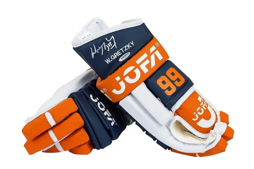 A pair of Edmonton Oilers full-size replica Jofa hockey gloves by Sports Integrity, signed "W. GRETZKY" in white ink and featuring the number 99. The gloves are displayed against a white background.