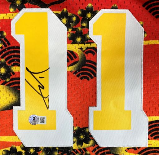 A close-up of the Yao Ming Signed Houston Rockets 2004-05 M&N Hardwood Classics Jersey by Sports Integrity shows large yellow and white number 11 on a red and black floral background, with one "1" autographed and an authentication sticker below.