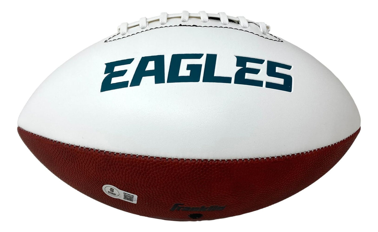 A white and brown Sports Integrity football with white laces, featuring "EAGLES" in bold blue letters and signed by Zack Baun, Philadelphia Eagles, BAS authenticated.