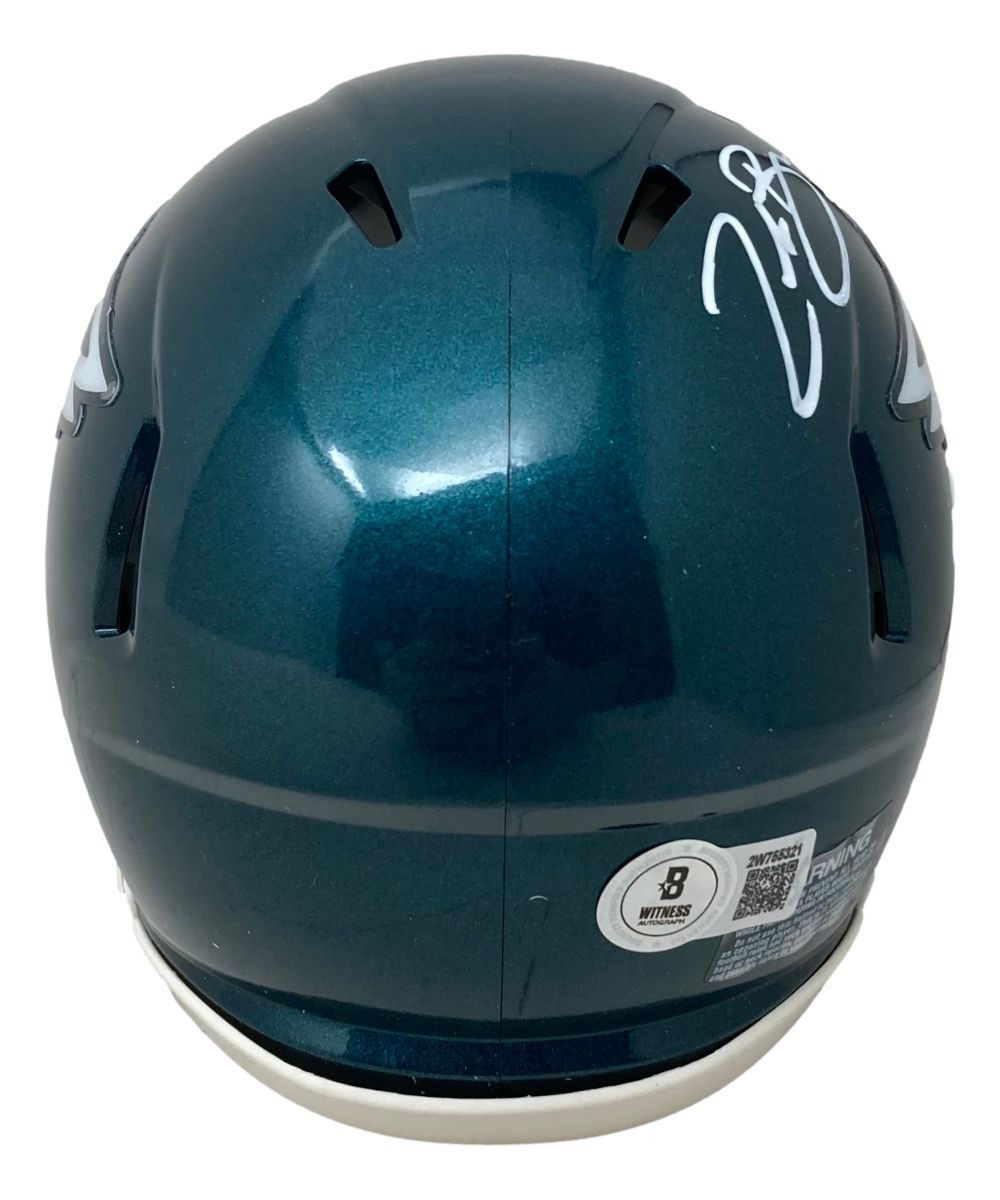 The Sports Integrity Zack Baun Signed Philadelphia Eagles Mini Speed Helmet BAS features a glossy green finish, white autograph on the top right, certification stickers near the base, and visible ventilation slots viewed from the back.