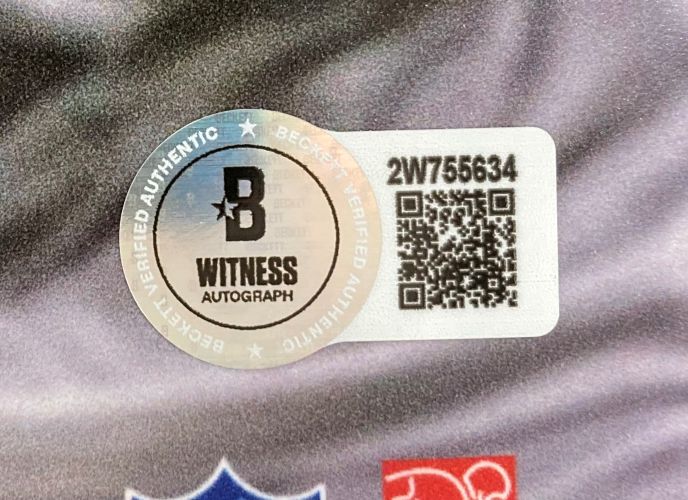 A Beckett Witnessed Autograph sticker with holographic B logo, QR code, and serial number 2W755634 is on the Zack Baun Signed 16x20 Philadelphia Eagles Super Bowl 59 Photo by Sports Integrity.